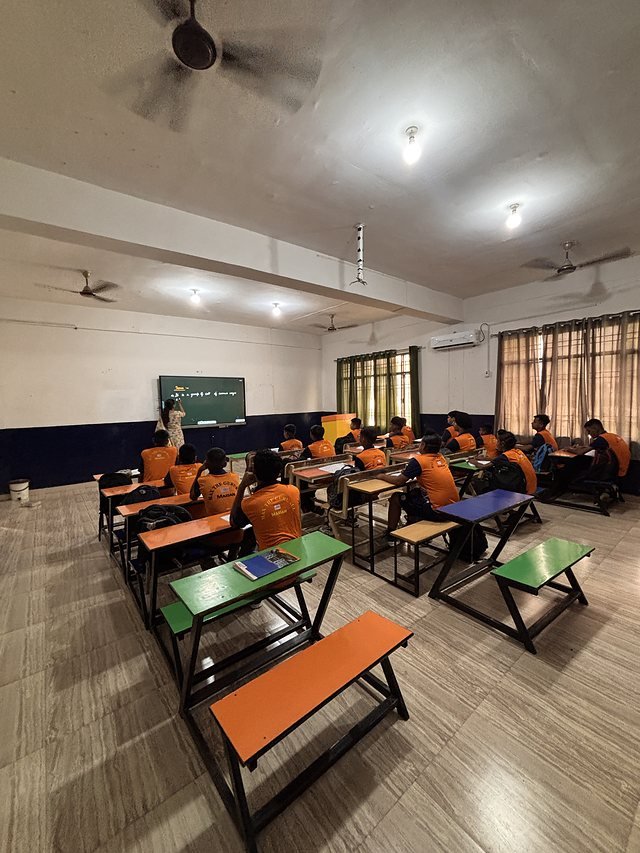 A wide view down a full classroom during a lesson