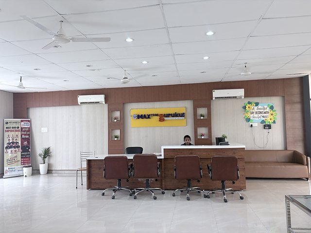 The school reception desk with signage and visitor seating