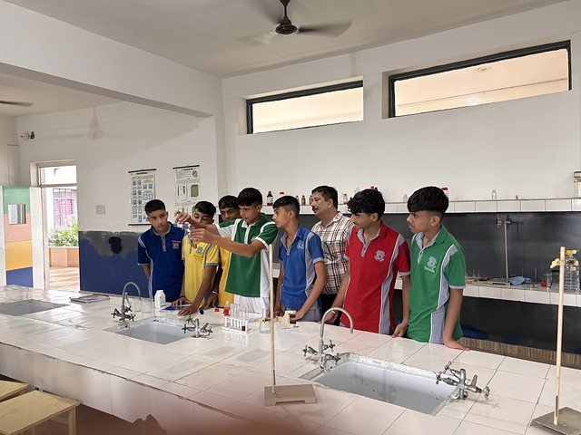 The full width of the science laboratory with students working along the bench